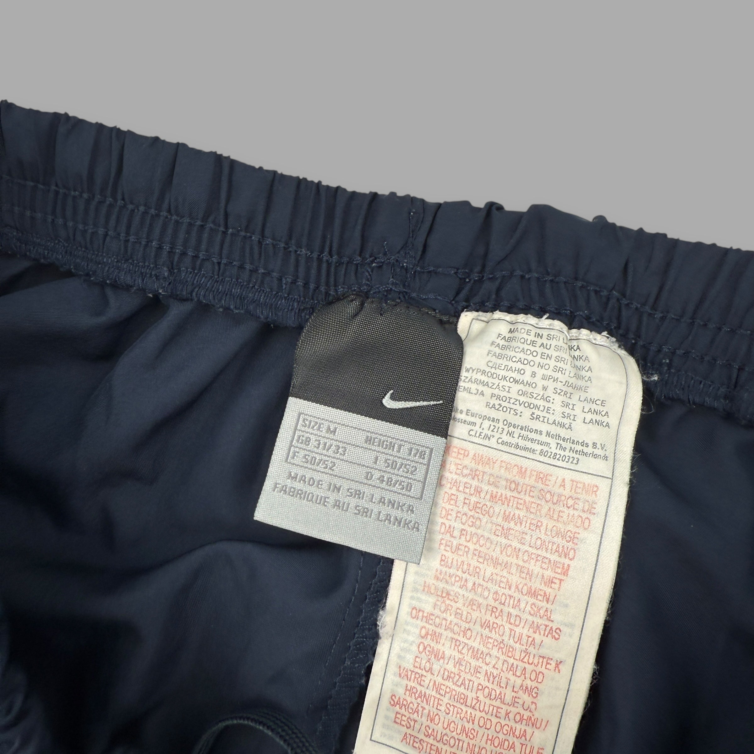 Nike 2000's baggy reflective nylon track bottoms (M)