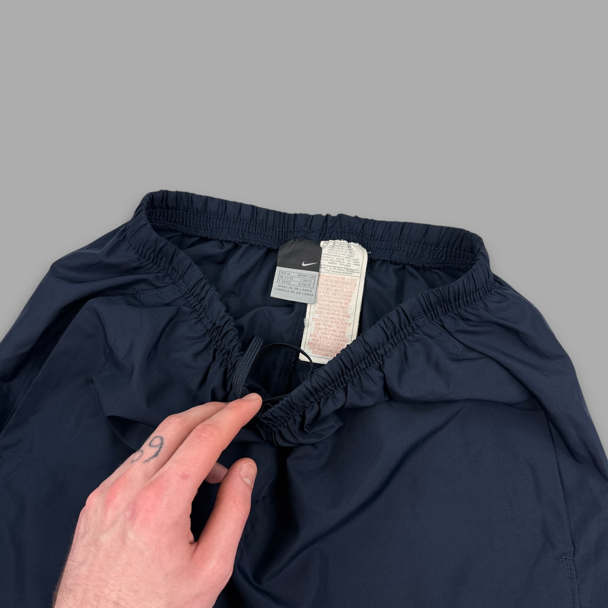 Nike 2000's baggy reflective nylon track bottoms (M)